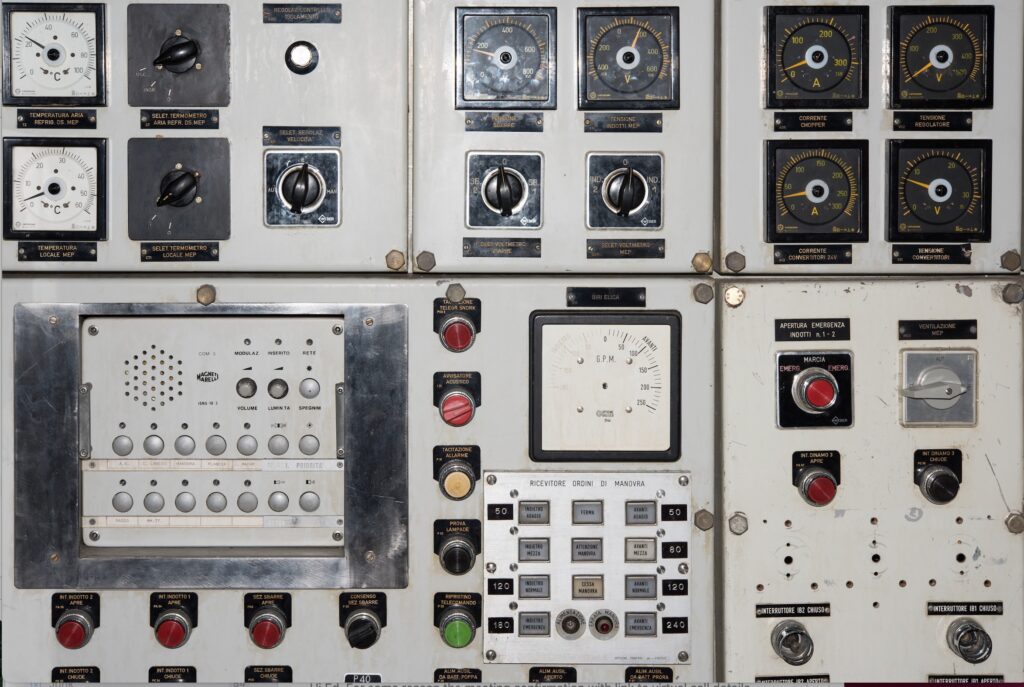 Vintage industrial control panel with gauges, dials, and switches, representing operational control systems in a business context.