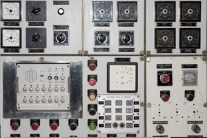 Vintage industrial control panel with gauges, dials, and switches, representing operational control systems in a business context.